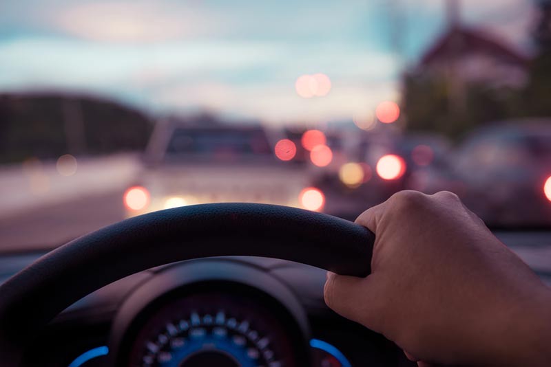 hand on a car steering wheel