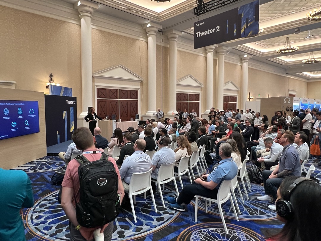 A crowded conference room with attendees attentively listening to Brenda Cowie, Senior Vice President of Strategic Growth at Orbus Software